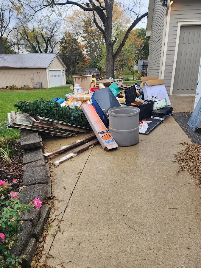 Dumpster being loaded with debris for 12 Yard Dumpster Rental in Emerald Isle